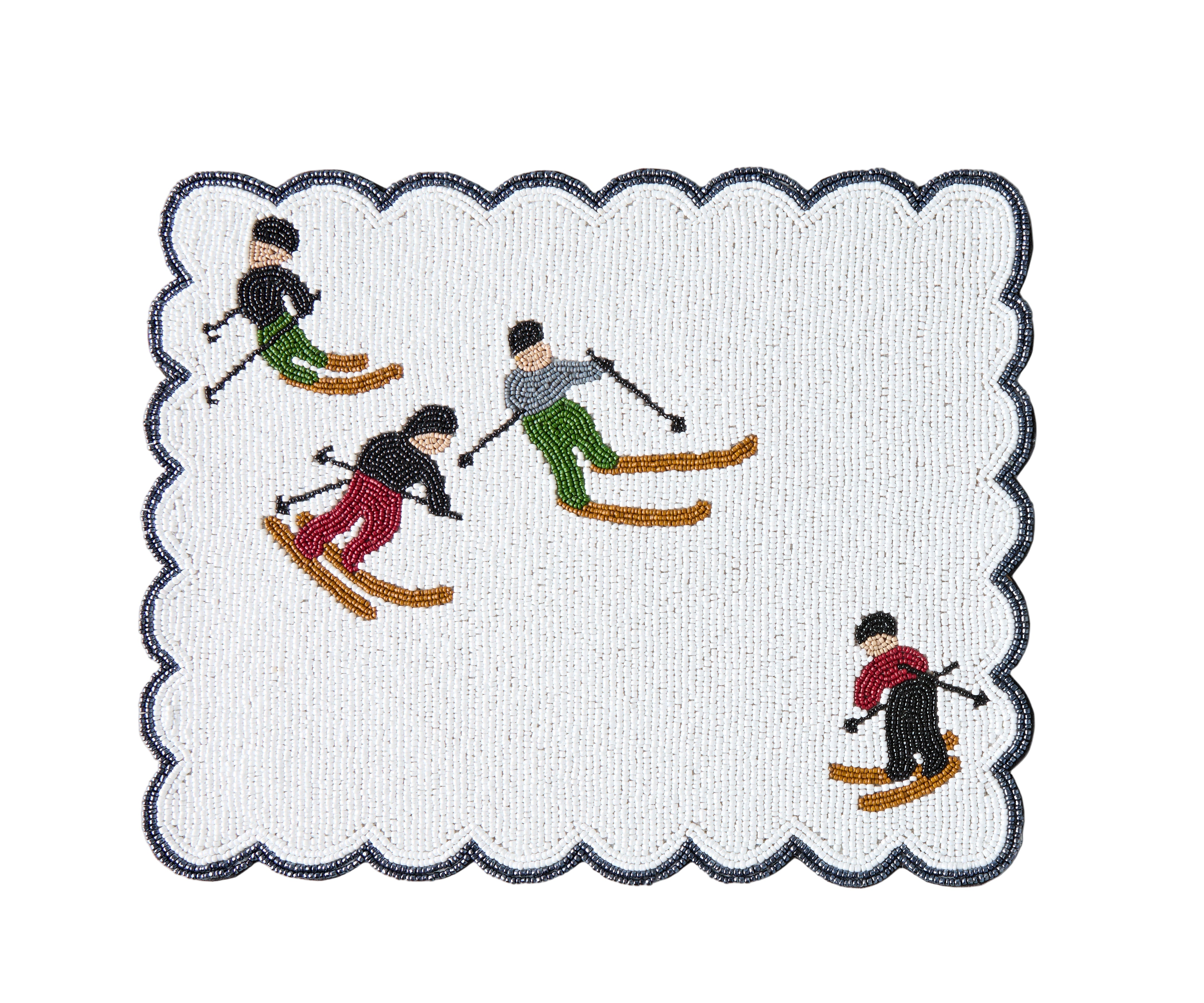 Embroidered placemat with skiers design on a white background