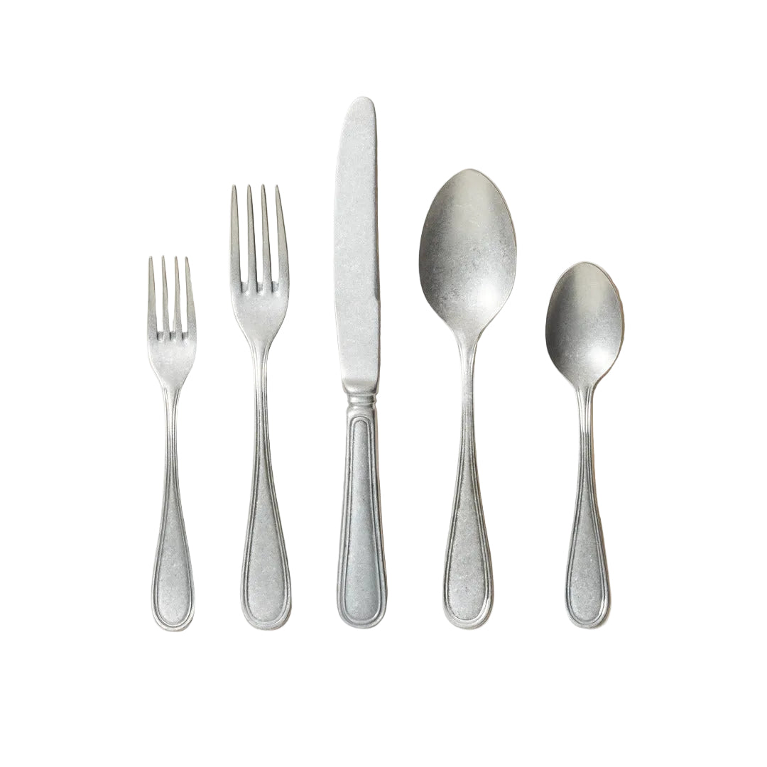 Set of silverware including two forks, a knife, and two spoons on a light background