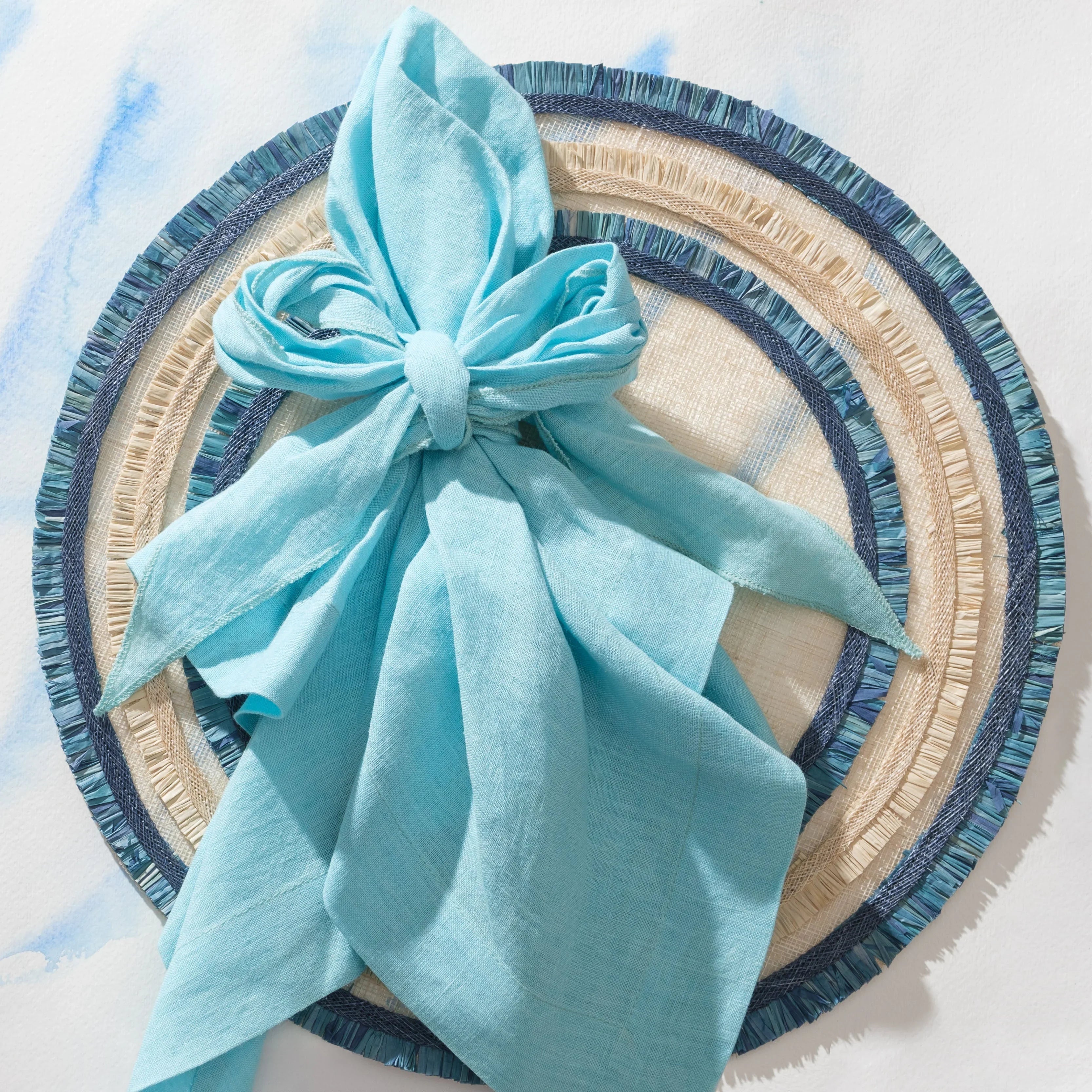 Ruffle edge straw placemat, indigo, set of four - The Mayfair Hall