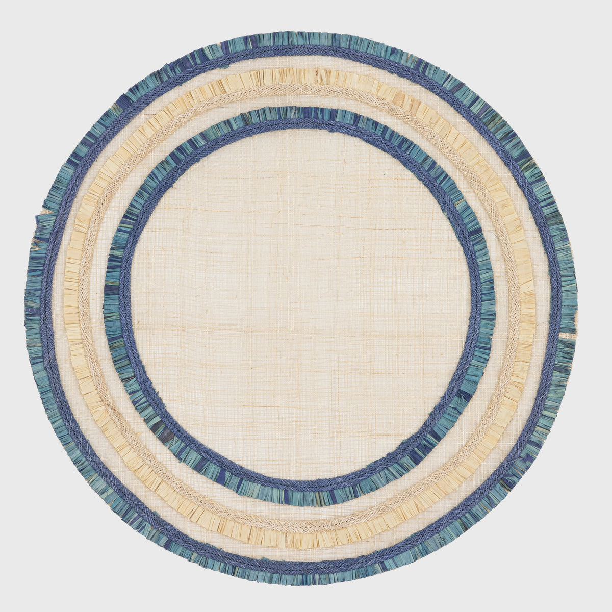 Ruffle Edge Abaca Placemats in Indigo — indigo abaca placemat shown from above on a plain background.