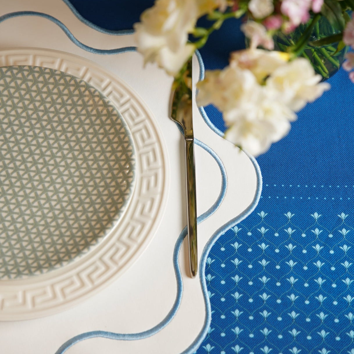 HAVEN WHITE WAVY EDGE BLUE TRIM FAUX LEATHER PLACEMAT