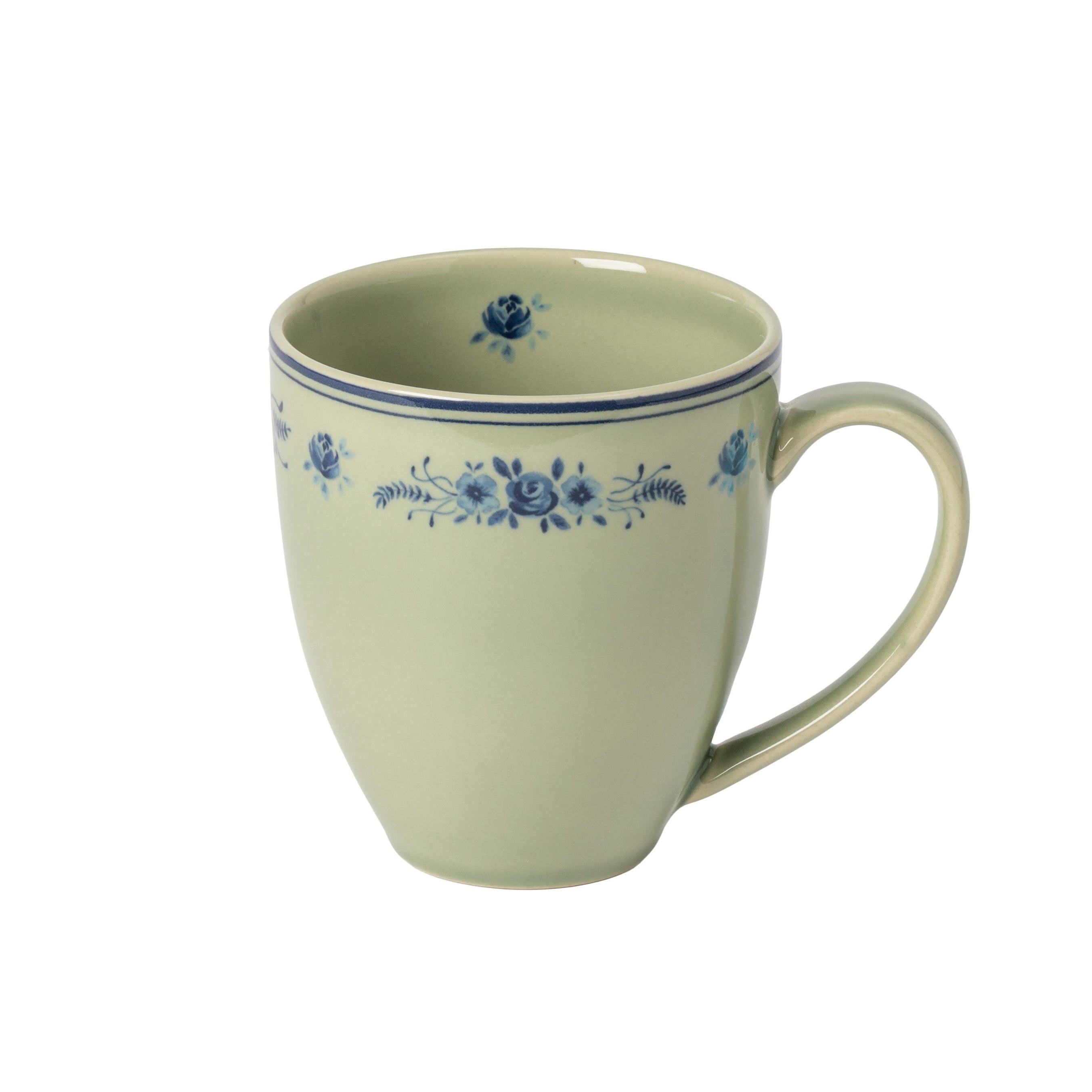 Ceramic mug with blue floral patterns on a green background