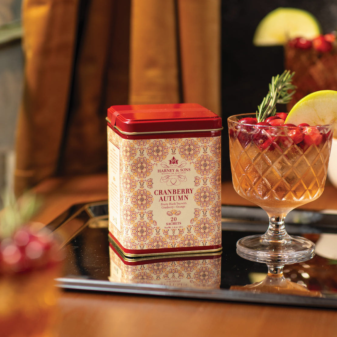 Cranberry autumn tea canister with a cocktail on a tray