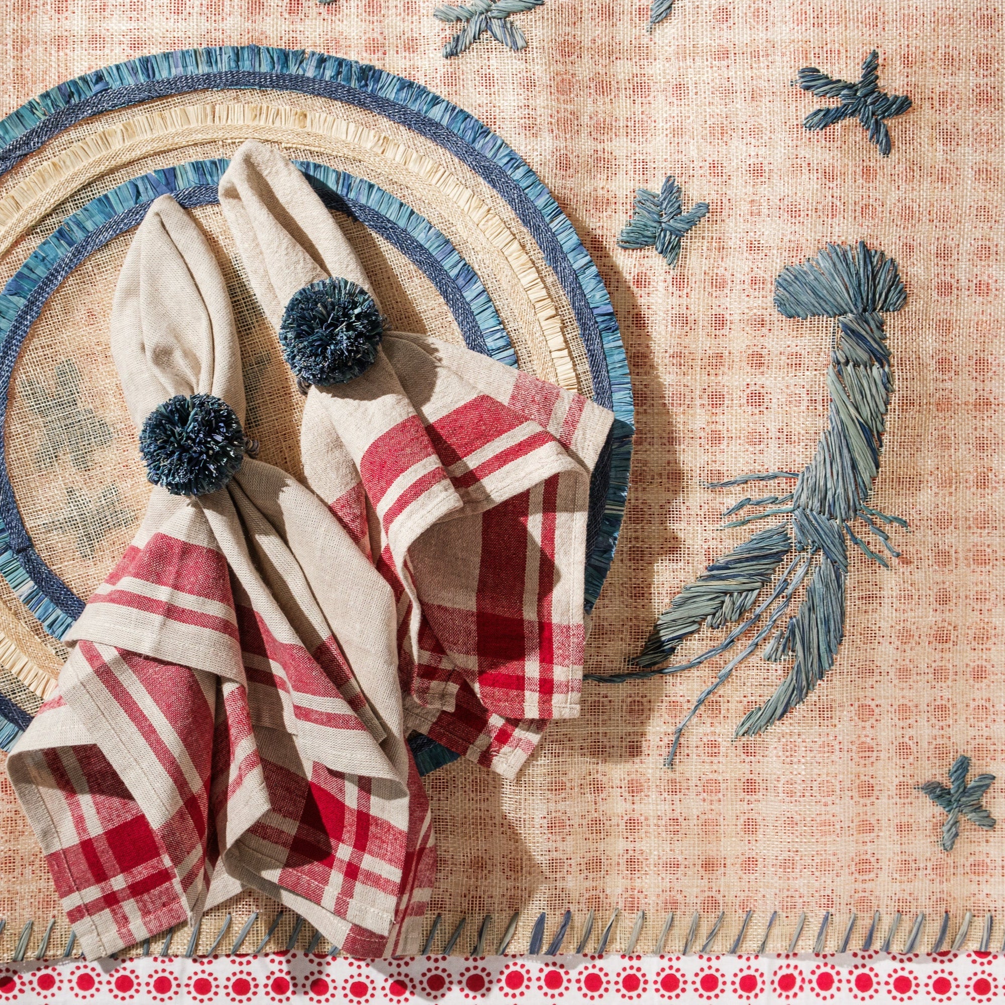 Straw pompom napkin rings, indigo, set of four